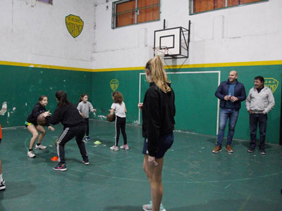 Molina observa a las chicas del básquet junto al presidente del club, Oscar Zinna.