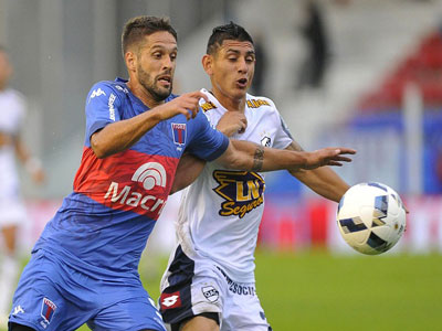 Orihuela y González pelean por la pelota; el de Tigre marcó uno de los tantos.